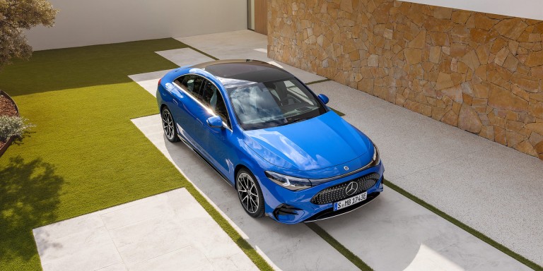 
				Blick von oben auf einen blauen CLA mit EQ-Technologie, der in einer Einfahrt vor einem Haus parkt.
				