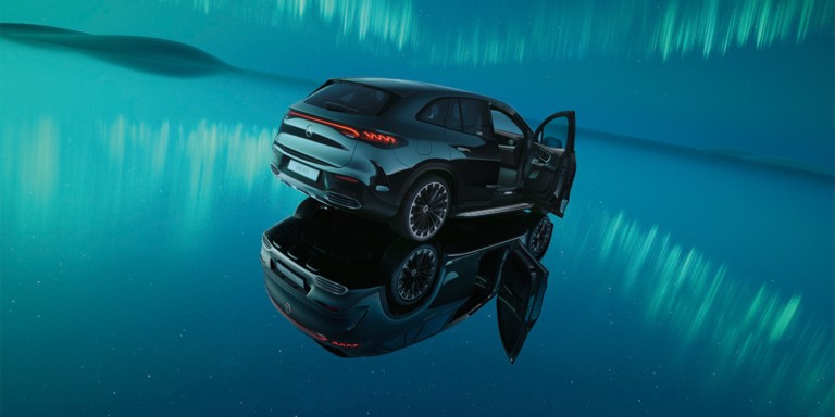 
				Ein schwarzer EQE SUV steht auf einer spiegelnden Oberflche unter Polarlichtern.
				