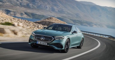 
						  Eine Mercedes-Benz E-Klasse auf einer Landstrae in karger Gebirgslandschaft.
						  
